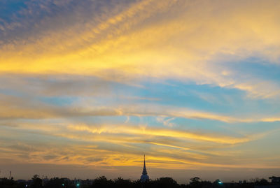 Silhouette of tower against sky during sunset