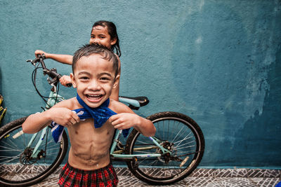 Portrait of smiling boy with bicycle