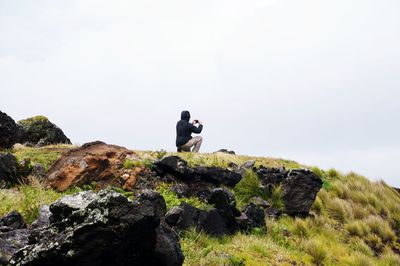 Man sitting on rock formation