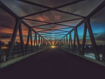 Bridge over river at sunset