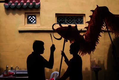 Men with chinese dragon at guanyin gumiao temple