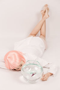 Young woman lying on white background