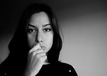 Close-up portrait of young woman over white background