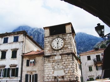 Low angle view of building against cloudy sky