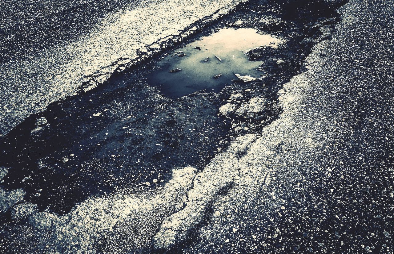 HIGH ANGLE VIEW OF PUDDLE ON STREET