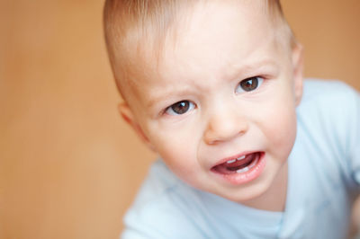 High angle view of cute baby boy crying at home