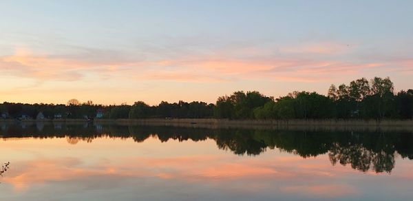 Scenic view of lake against sky during sunset