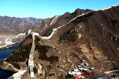 Scenic view of mountain range with the great wall of china against sky