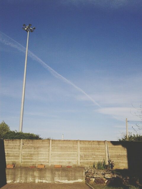 street light, sky, lighting equipment, blue, built structure, building exterior, transportation, low angle view, architecture, cloud - sky, day, road, copy space, outdoors, pole, clear sky, street, cloud, no people, sunlight