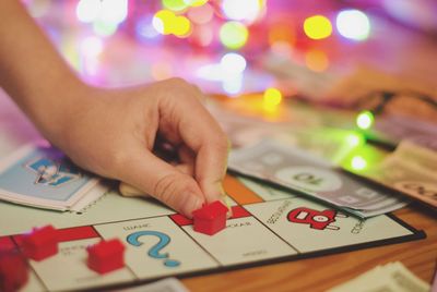 Close-up of hand holding illuminated text on table