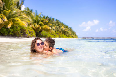 Portrait of young woman swimming in sea