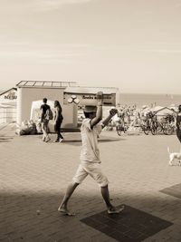 Women on beach against sky