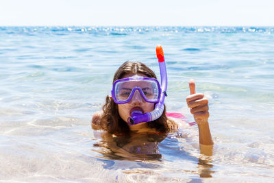 Portrait of woman swimming in sea