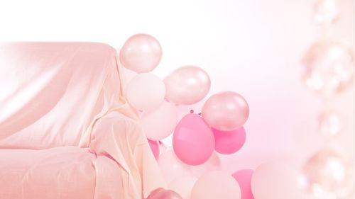 Low angle view of pink balloons against sky