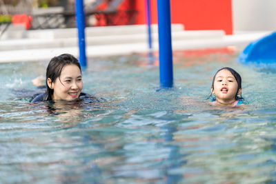 Portrait of a smiling girl swimming in pool