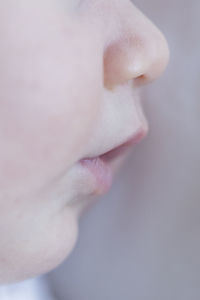 Close-up of baby girl on bed at home