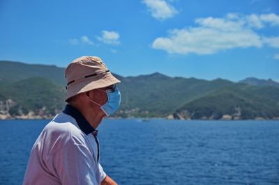 Portrait of man in sea against mountains