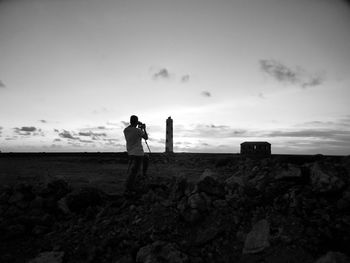 Rear view of man standing on rock