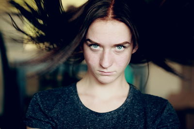 Portrait of angry young woman at home