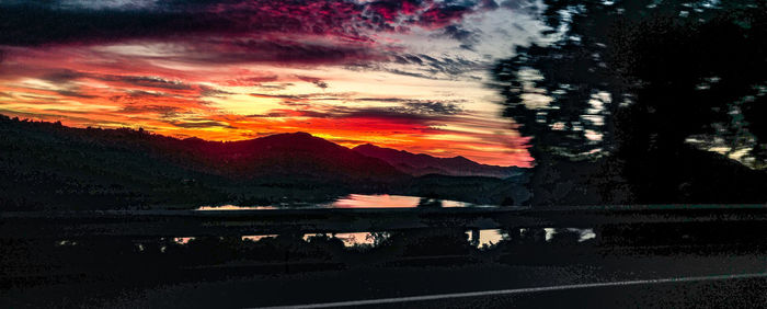 Scenic view of mountain against sky at sunset