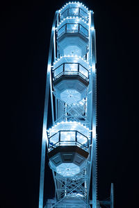 Low angle view of illuminated ferris wheel at night