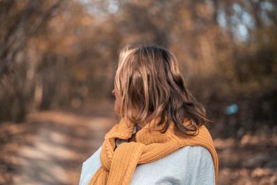 Woman standing in forest during winter