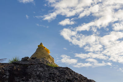 Low angle view of rock formation against sky