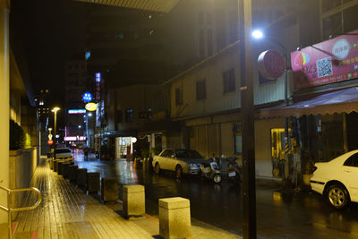 Cars on illuminated street at night