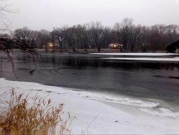 Scenic view of frozen lake against sky during winter