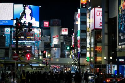 People on illuminated street at night