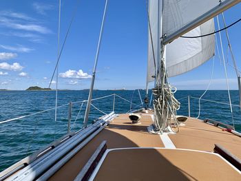 Sailboat sailing in sea against sky