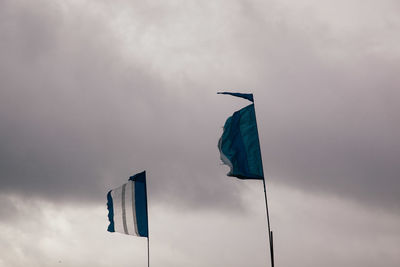 Low angle view of pole against cloudy sky