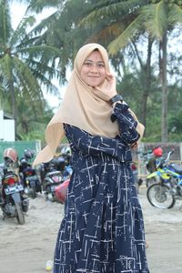 Portrait of smiling young woman standing outdoors