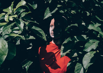 Close-up of a young woman with leaves