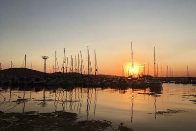 Sailboats in marina at sunset