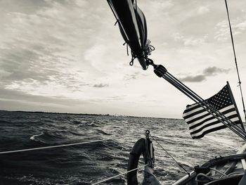 Man on boat in sea against sky