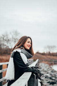 Young woman standing in snow