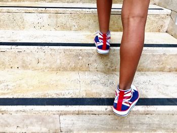 Low section of woman standing on steps