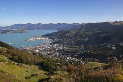 High angle view of townscape by sea against clear sky