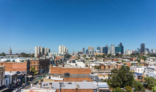 High angle view of buildings against blue sky