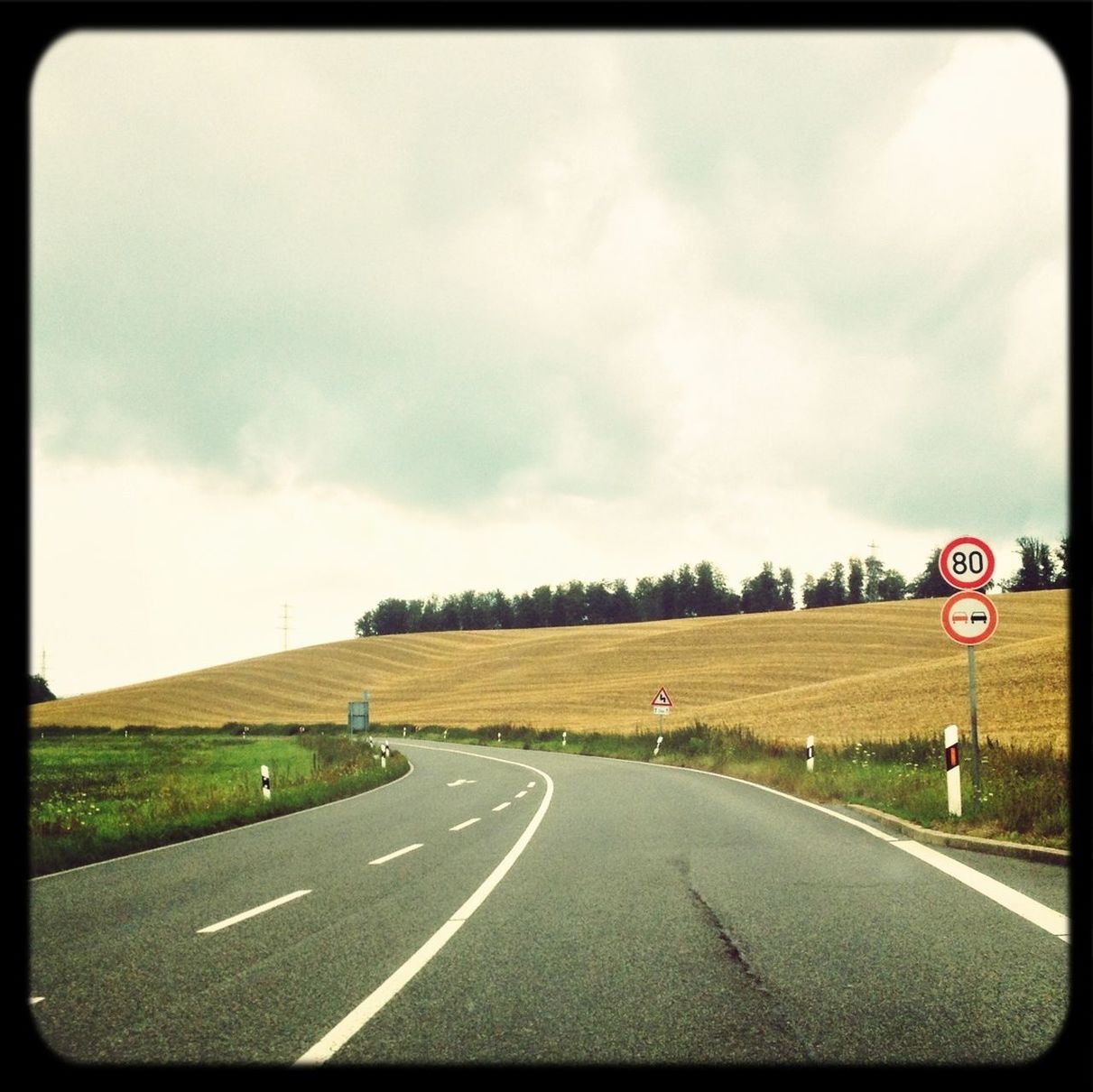 transportation, road, road marking, the way forward, sky, road sign, diminishing perspective, country road, cloud - sky, transfer print, vanishing point, landscape, communication, street, guidance, auto post production filter, cloudy, asphalt, highway, arrow symbol