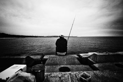 Rear view of people looking at sea