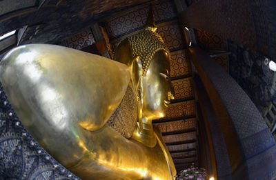 Close-up of golden buddha statue in temple