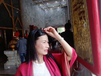 Smiling mature woman looking away in temple