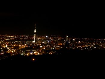 High angle view of illuminated cityscape against sky at dusk