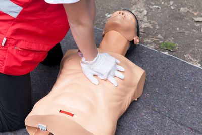 Low section of woman standing on hand