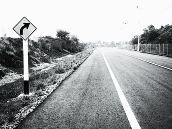 Road sign against clear sky