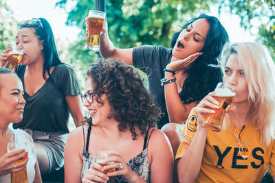 Female friends enjoying beer at party