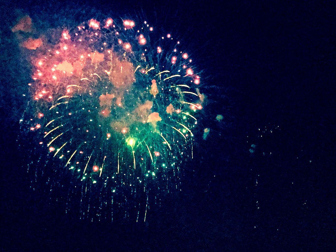 LOW ANGLE VIEW OF FIREWORKS DISPLAY AT NIGHT