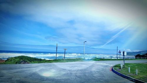 Empty road against cloudy sky